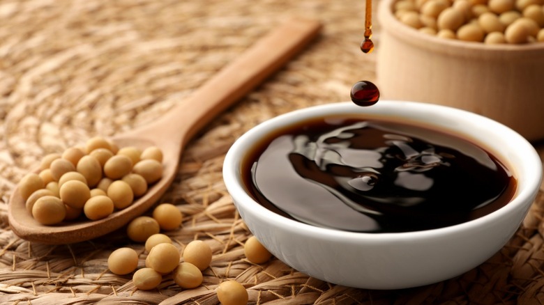 Soy sauce surrounded by soy beans