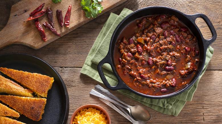 Kettle of homemade chili with cornbread