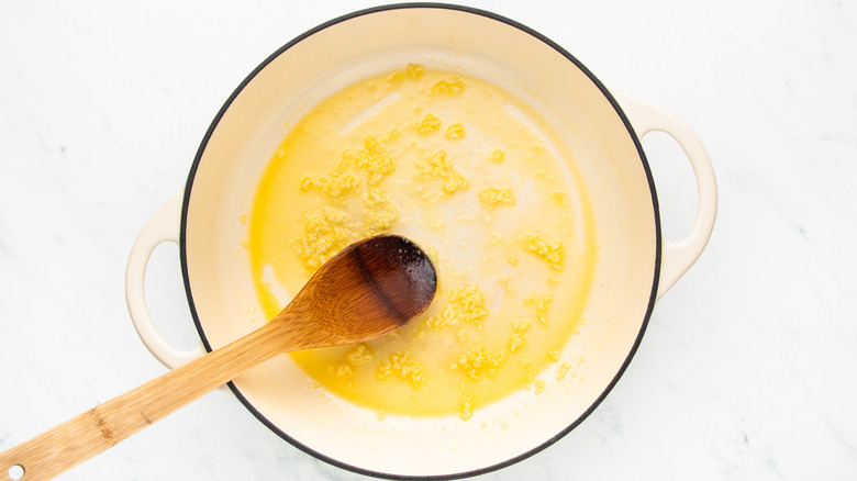 sauteing minced garlic in butter