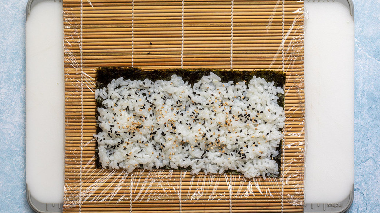 nori and rice on sushi mat