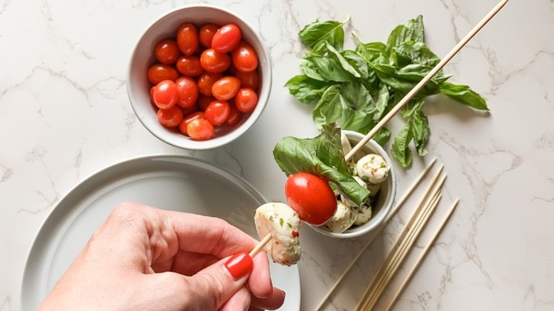 assembling caprese skewer