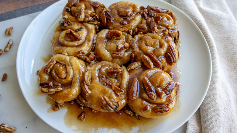 a platter of caramel buns with pecans