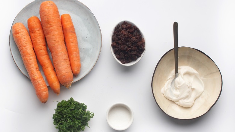 The ingredients for easy carrot raisin salad 