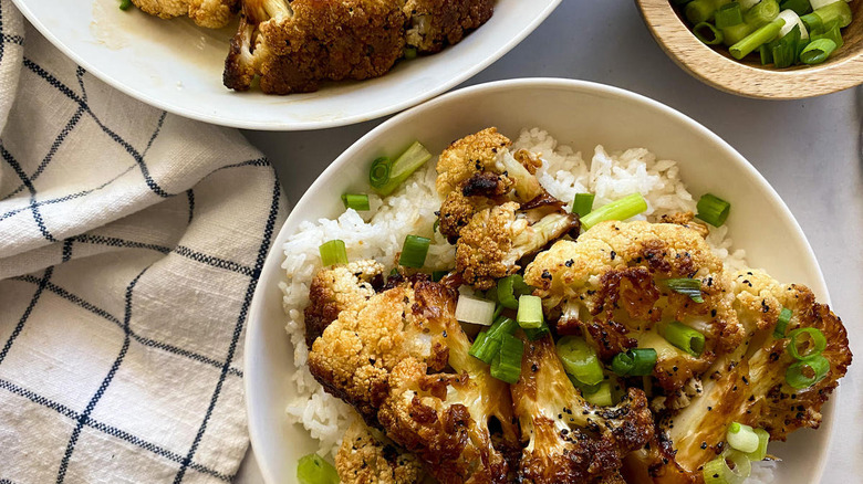 Cauliflower Adobo on rice on plates