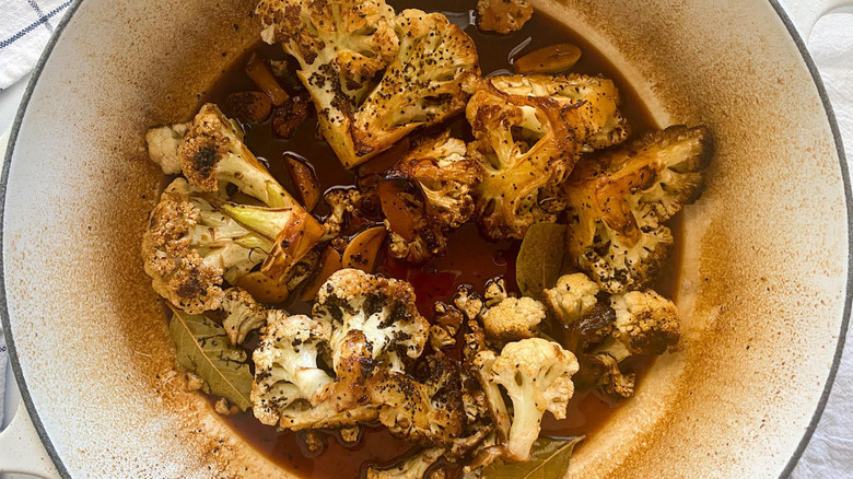 cooked cauliflower and adobo liquids in Dutch oven pot