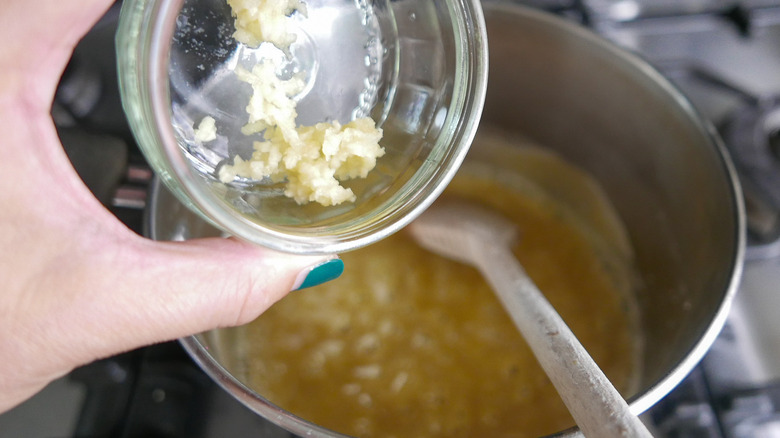 garlic going into sauce 