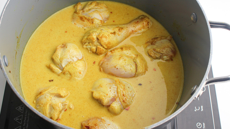 chicken in pot with spices 