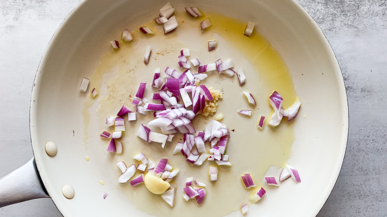 skillet sautéing onion and garlic