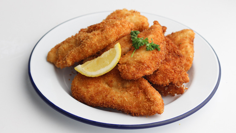 Chicken schnitzel on white plate