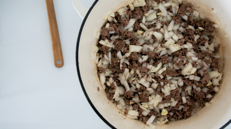 Ground beef and onions in a pan