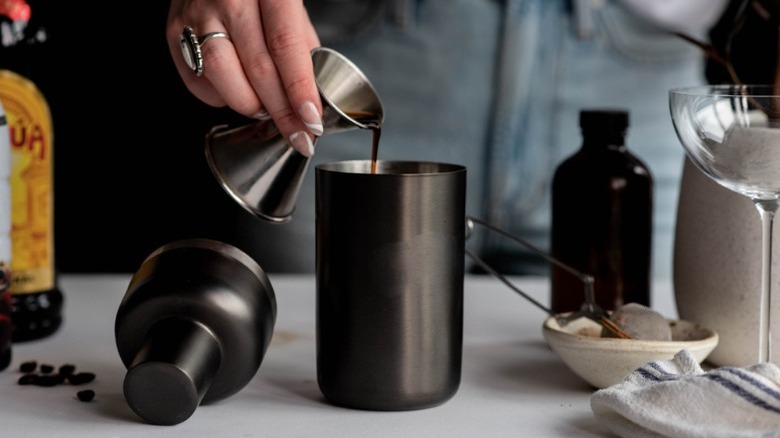 pouring coffee liqueur into shaker