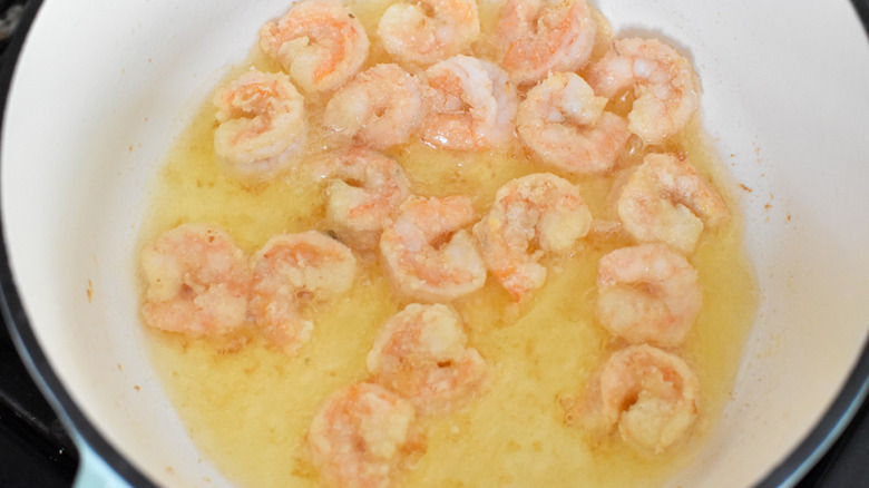 shrimp cooking in a pan 