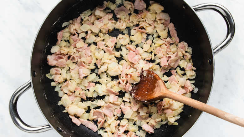 onion and bacon cooking in pot