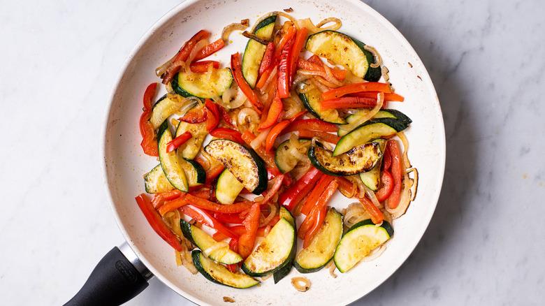 Sautéed summer vegetables in a skillet.