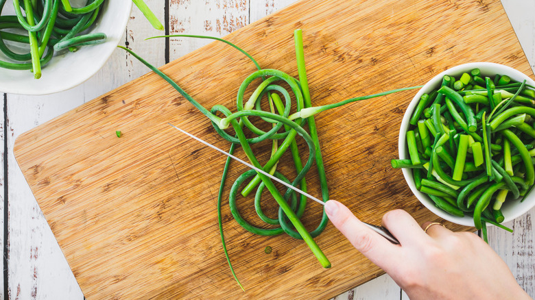 garlic scapes on cutting board