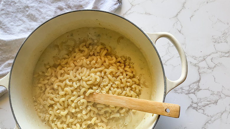 Macaroni added to the cheese sauce