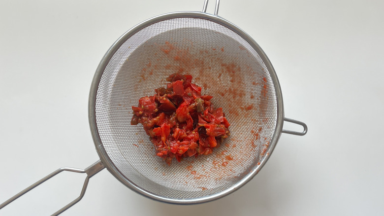 strained tomatoes in colander