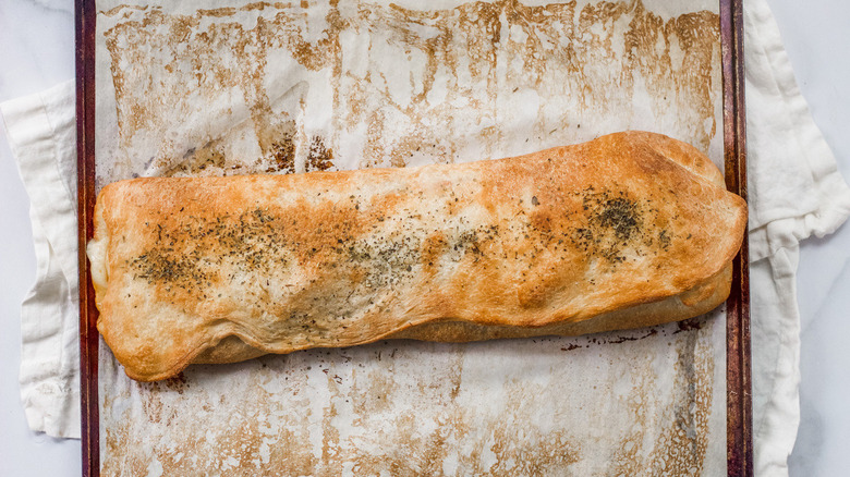 baked stromboli on a baking sheet