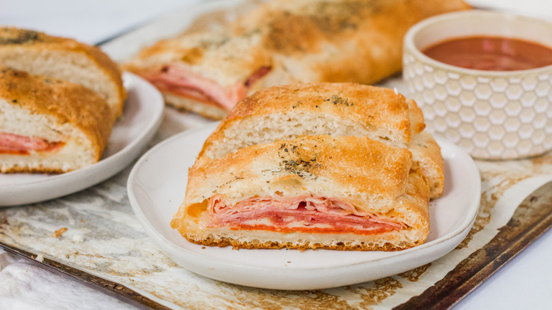 two plates of stromboli and marinara dipping sauce