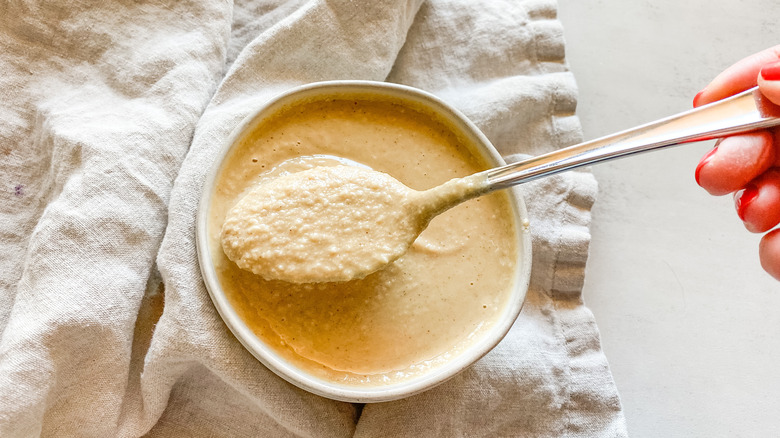 tahini in bowl with spoon