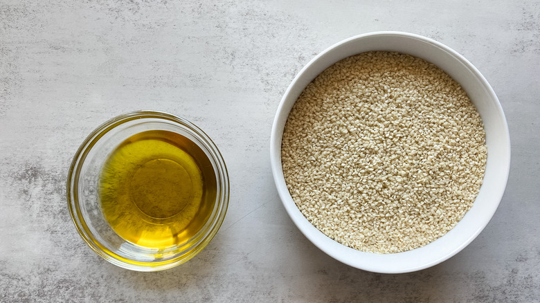 sesame seeds and olive oil in bowls