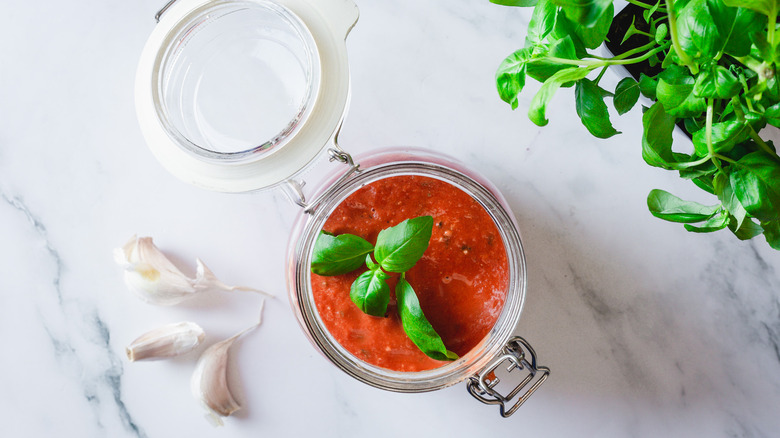 sauce in jar with basil