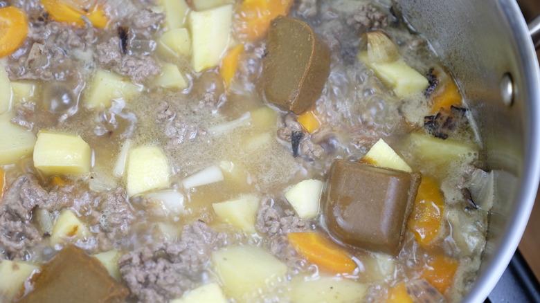 Adding curry roux cubes into the beef mixture