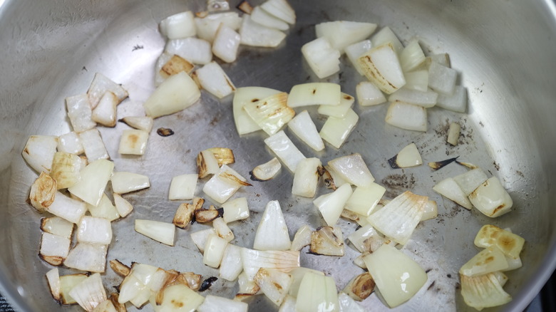 Sautéing diced onions in a hot pan