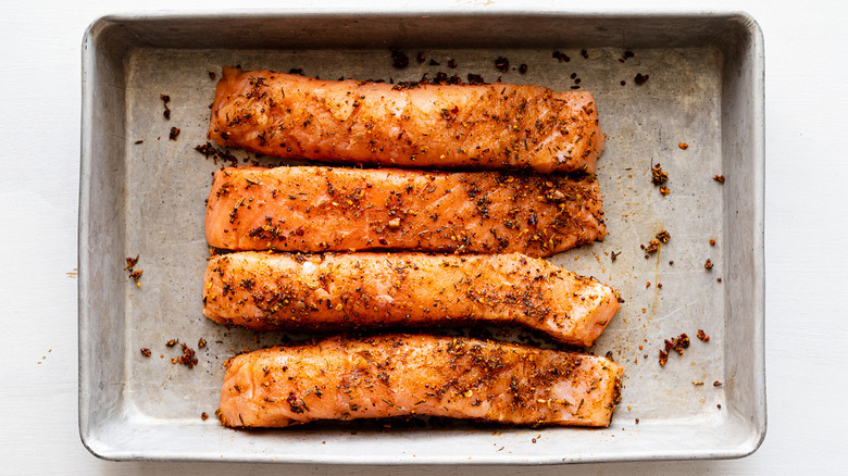 salmon fillets on baking sheet