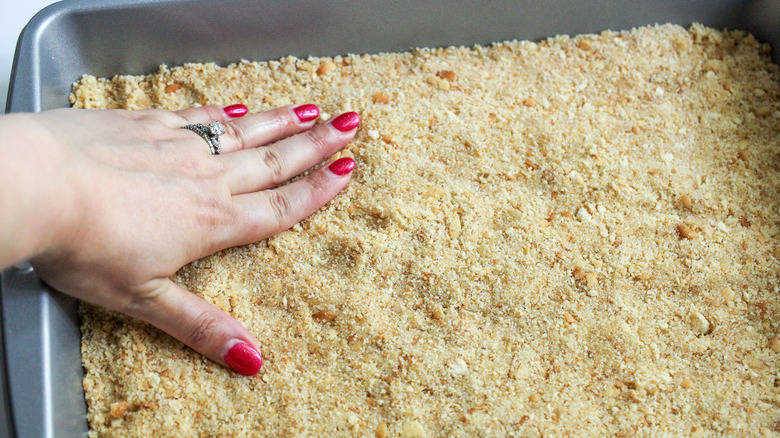 hand pressing down on crust