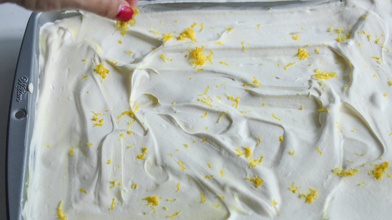 sprinkling lemon zest on lemon lush