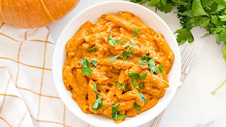 Pumpkin pasta in a bowl with a fork