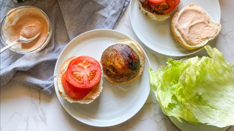 A mushroom burger with lettuce and tomato slices