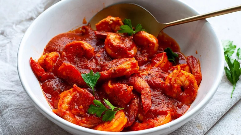 A bowl of shrimp in tomato sauce