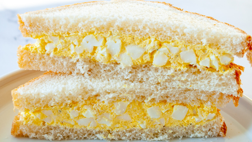 two stacked egg salad sandwiches