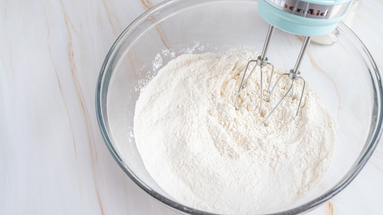 dry ingredients for marble cake in bowl with hand beaters