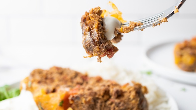 Mexican meatloaf slice on plate and piece on fork