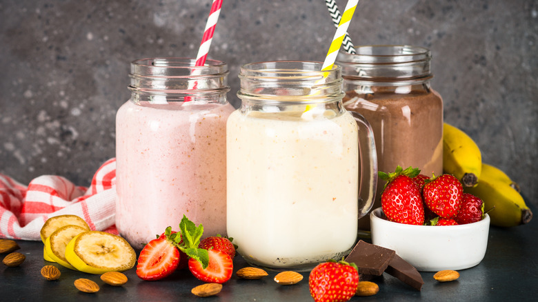 A trio of milkshakes with fruit