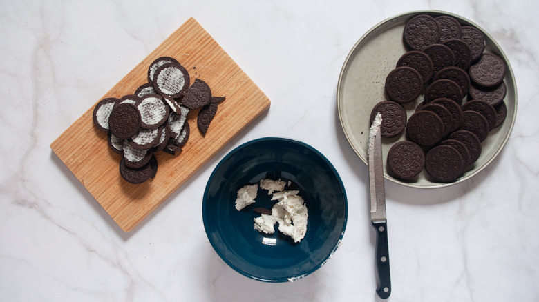 Oreo cookies on plate with cream filling separated, and filling from above