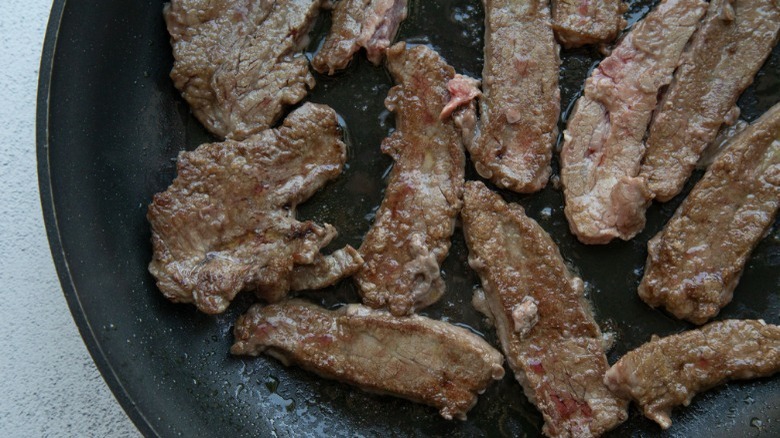 cooked steak pieces in skillet