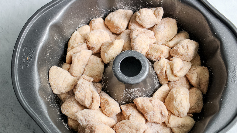 coated dough pieces in pan