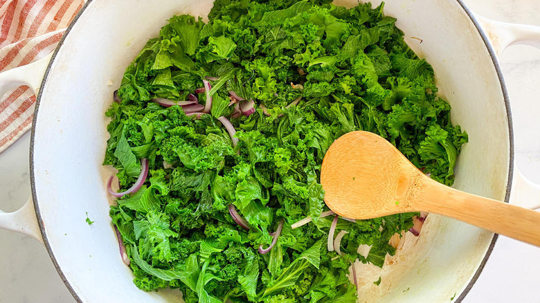 greens and onion in pot