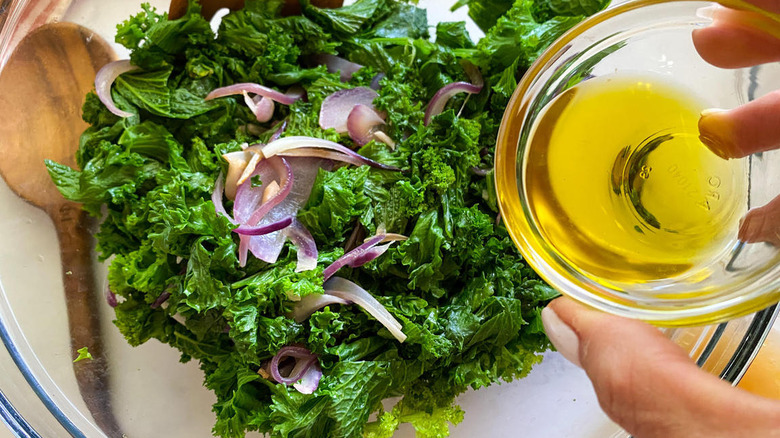 pouring oil into salad