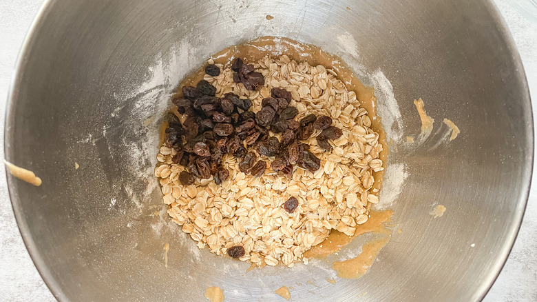 Ingredients for oatmeal raisin muffins in a bowl