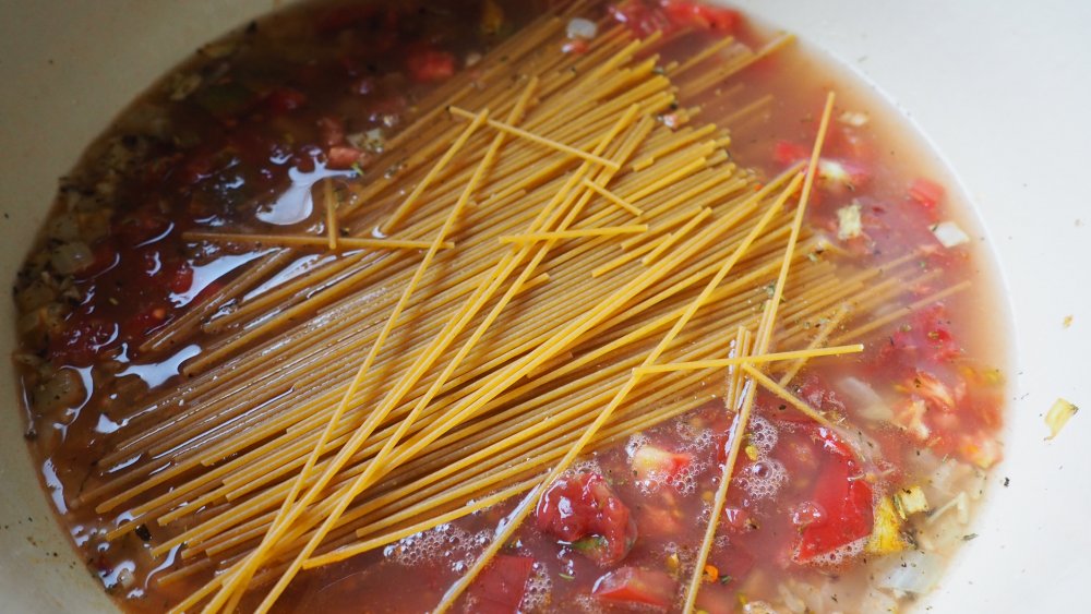 pasta in pasta sauce for one-pot pasta recipe with spinach and tomatoes