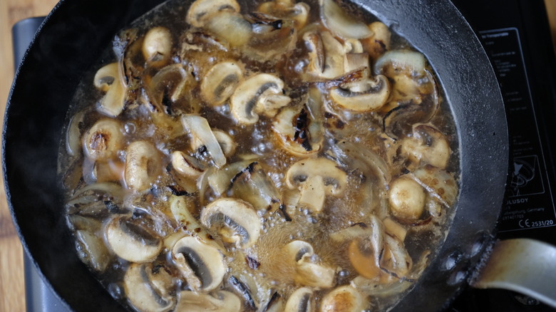 Onions and mushrooms caramelizing in skillet