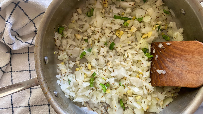 onion, garlic, ginger, pepper, and cumin seeds in pan