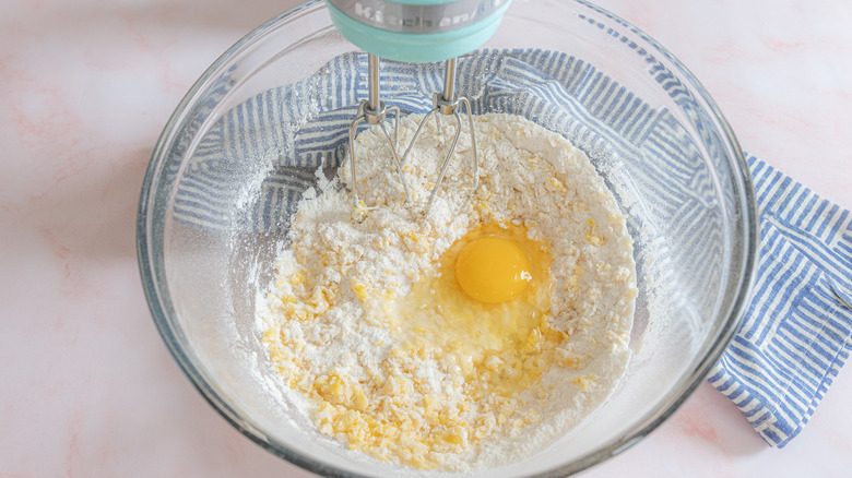 adding egg into dry ingredients