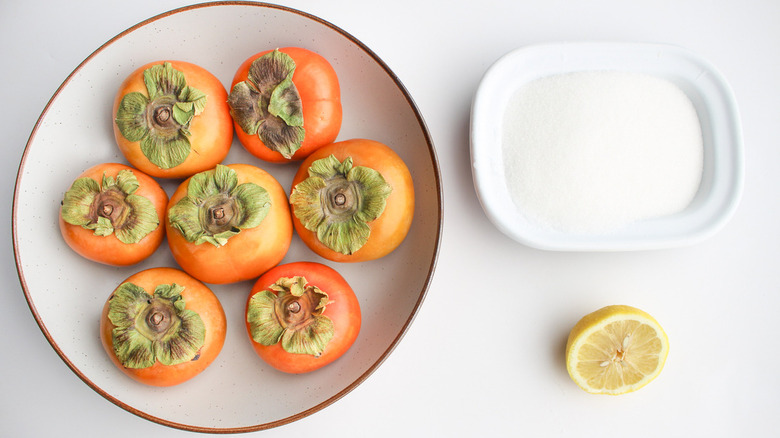 Persimmons, sugar, and half lemon