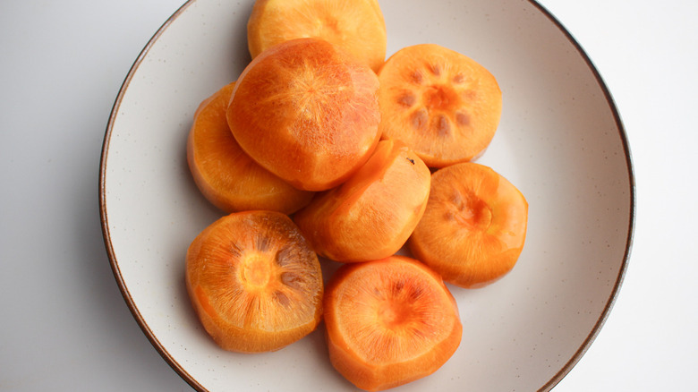peeled persimmons on plate